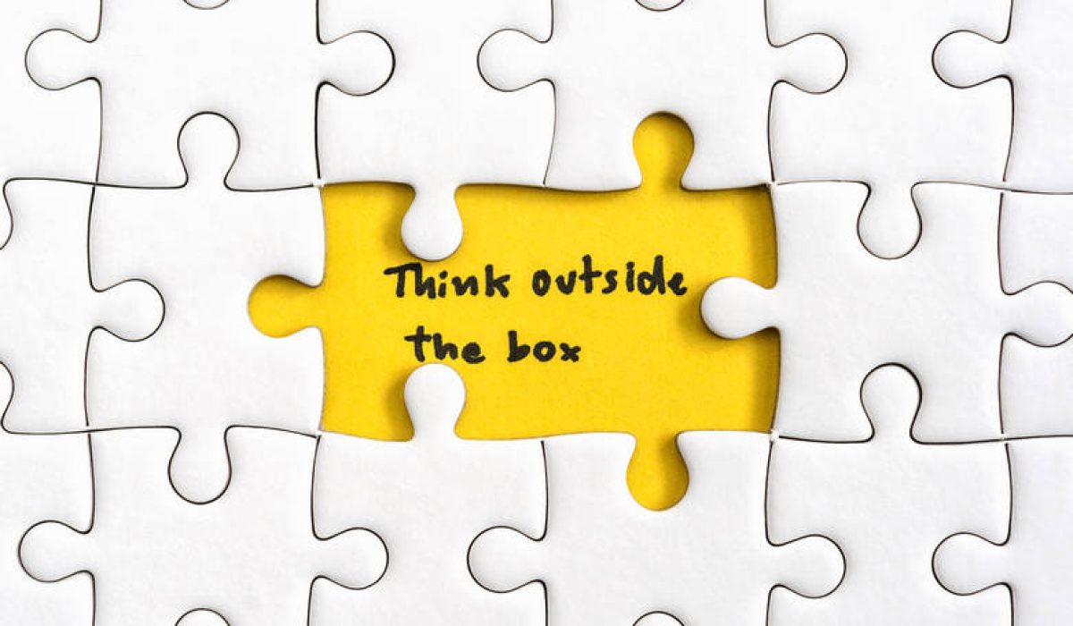 Jigsaw puzzle piece with two missing and hand writing letters word think outside the box, Quotes business concept